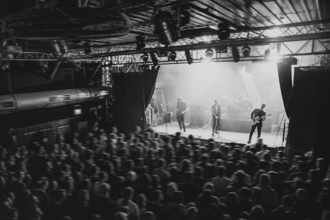 Rock band playing a concert at a live house in Europe